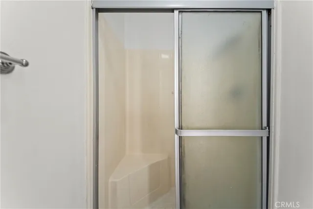 a bathroom with a glass shower door