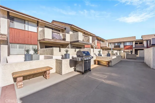 a view of a patio with table and chairs and potted plants