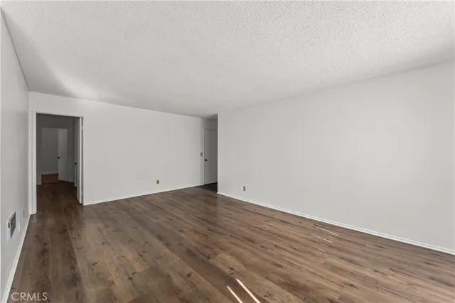 a view of an empty room and wooden floor