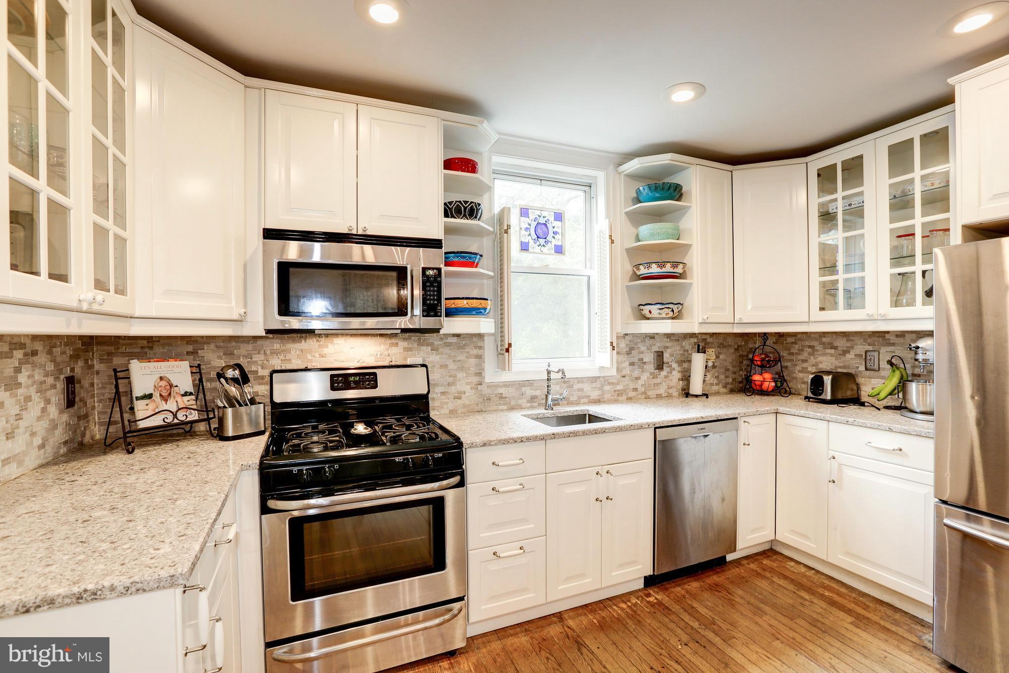911 Arran Road Baltimore, MD 21239 - Photo 8 of 30 a kitchen with a sink stove top oven and cabinets