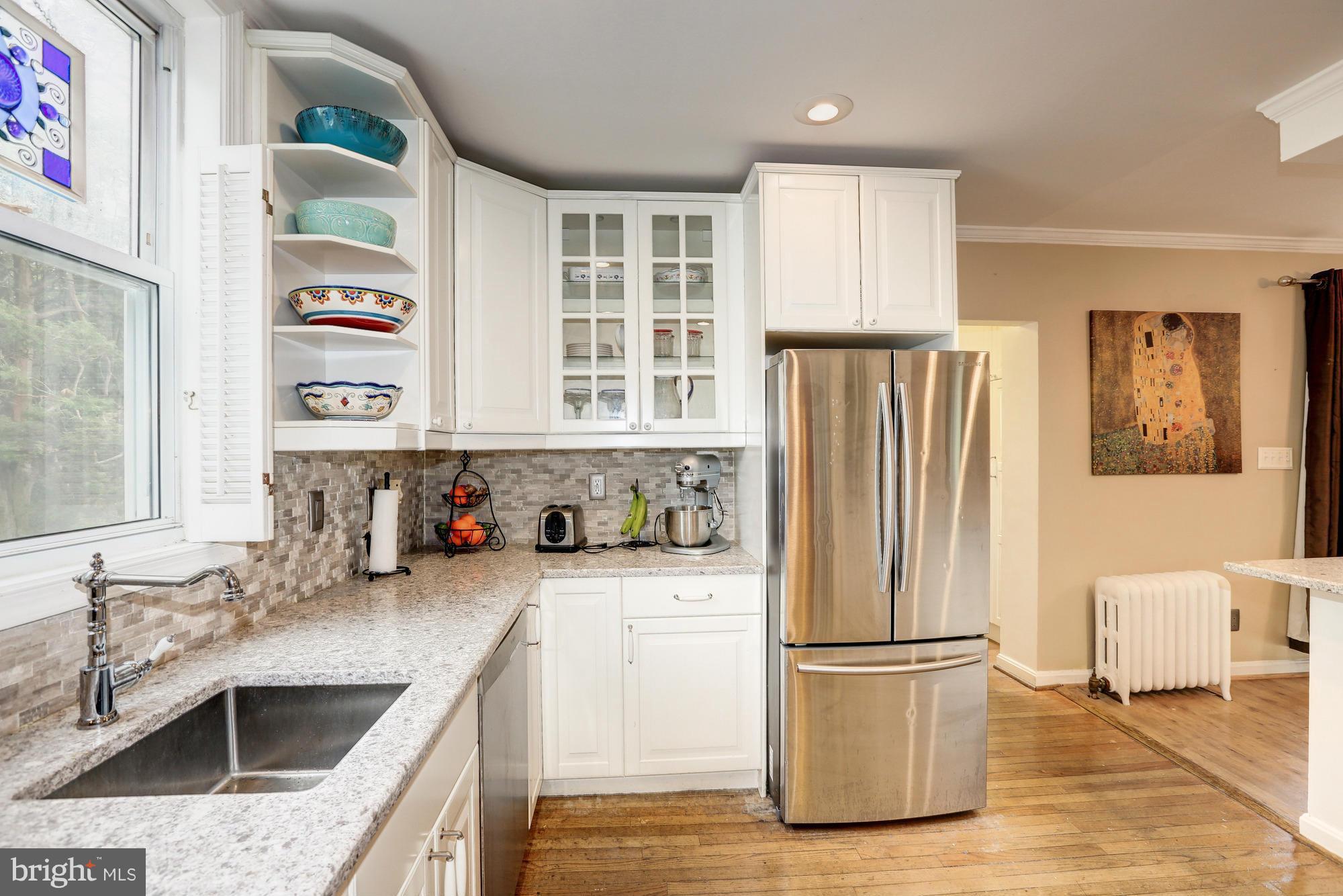 911 Arran Road Baltimore, MD 21239 - Photo 9 of 30 a kitchen with a sink a refrigerator and cabinets