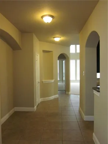 a view of a hallway with wooden shelves