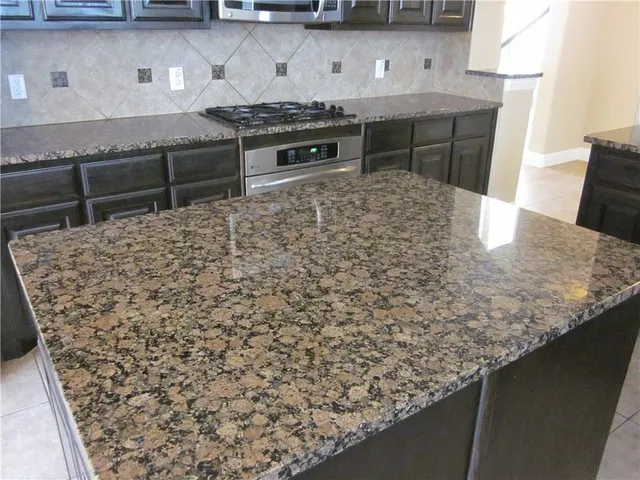 a kitchen with a stove and a refrigerator