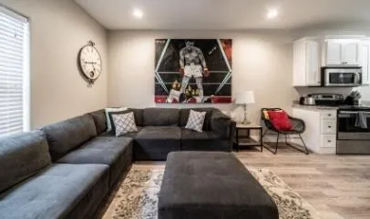 a living room with furniture a rug and white walls