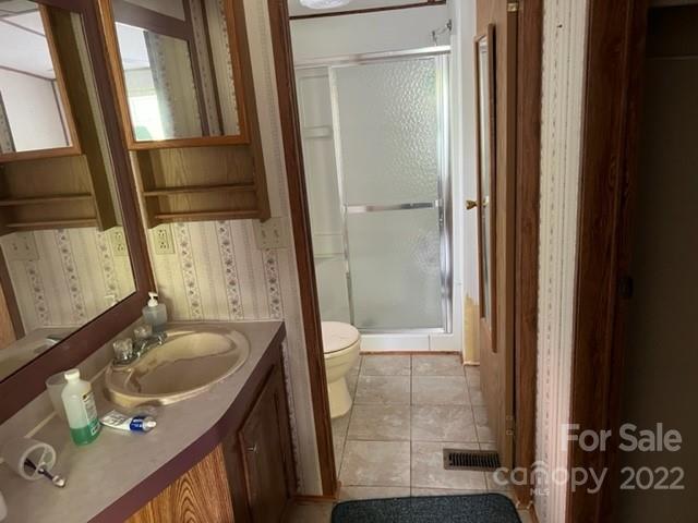 270 Adams Road Rutherfordton, NC 28139 - Photo 15 of 31 a bathroom with a sink and mirror with bathtub