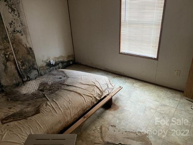 270 Adams Road Rutherfordton, NC 28139 - Photo 19 of 31 a bed sitting in a bedroom next to a window