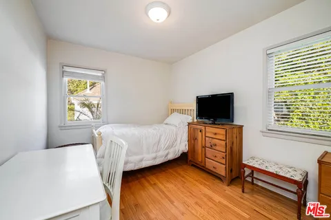 a bedroom with a bed and flat screen tv