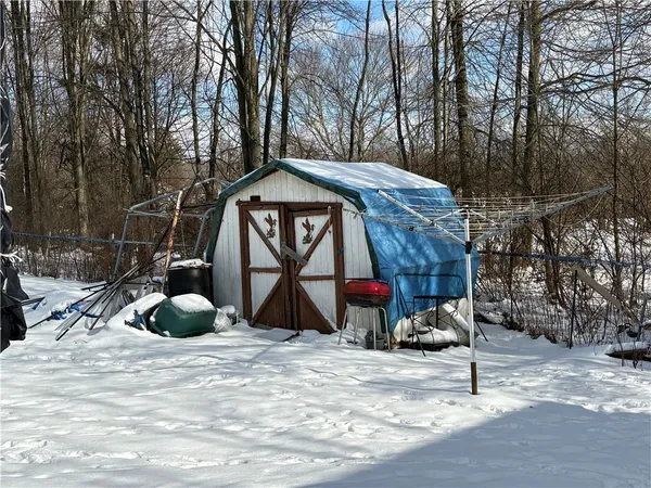 a wooden bench sitting in front of a building