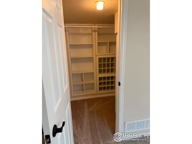 a view of a room with door and white wall