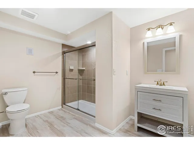 a bathroom with a toilet sink a shower and