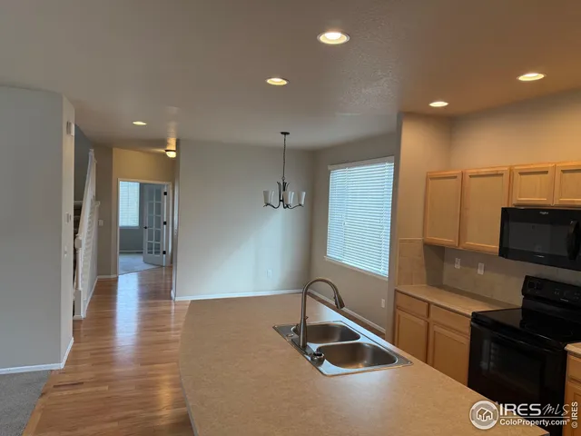 a kitchen with stainless steel appliances a refrigerator and a stove top oven