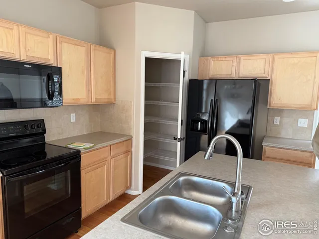 a kitchen with a stove a sink and a microwave