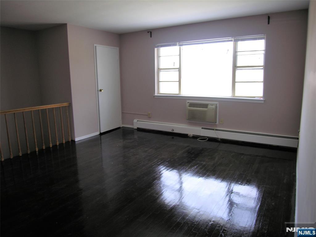 1143 Valley Road, Unit 30 Wayne, NJ 07470 - Photo 11 of 17 a view of an empty room with wooden floor and a window
