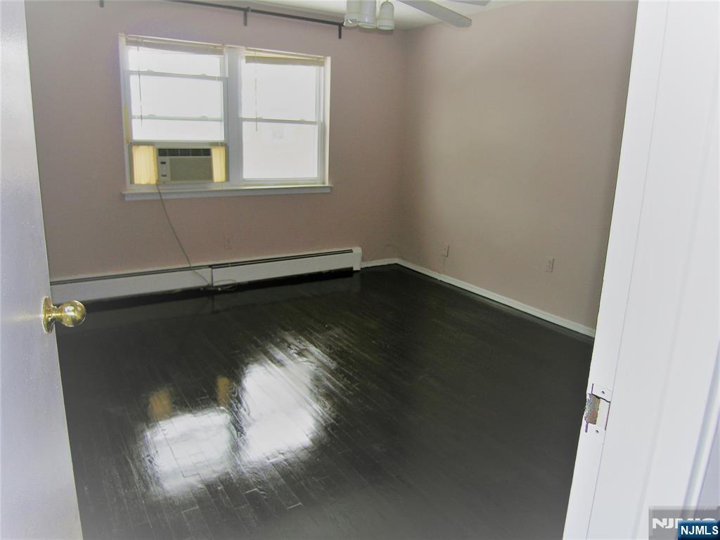1143 Valley Road, Unit 30 Wayne, NJ 07470 - Photo 14 of 17 an empty room with wooden floor and windows