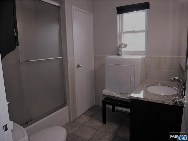 a bathroom with a sink toilet and a mirror