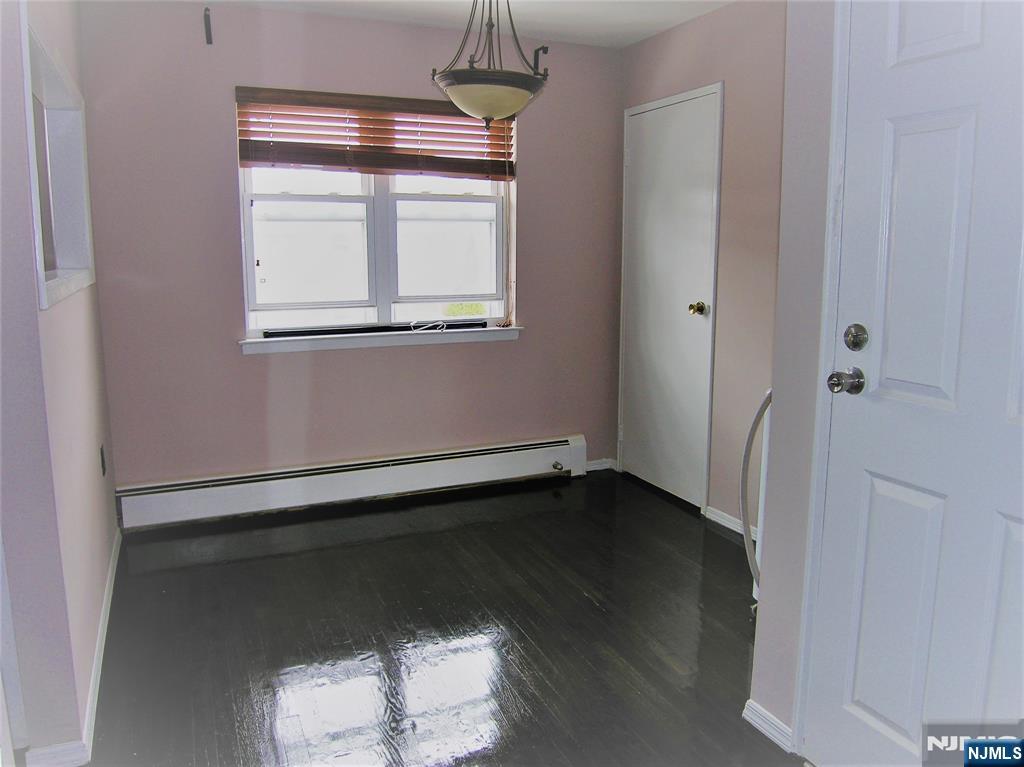 1143 Valley Road, Unit 30 Wayne, NJ 07470 - Photo 6 of 17 an empty room with wooden floor and windows