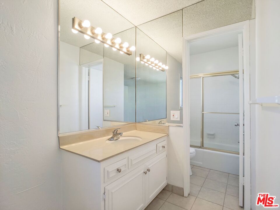 1538 11th, Unit 3 Santa Monica, CA 90401 - Photo 4 of 6 a bathroom with a sink a light fixture and a mirror