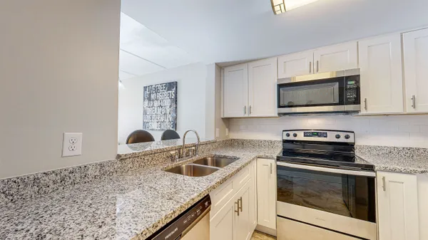a kitchen with a sink stove and microwave