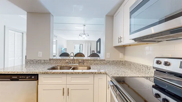 a kitchen with appliances cabinets and a counter top space