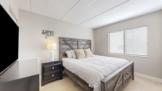 a bedroom with a bed and a window