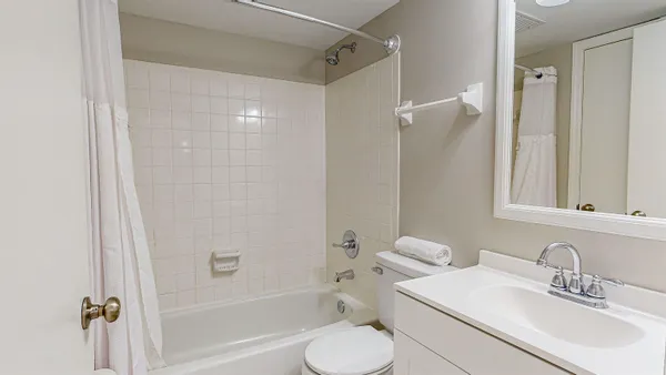 a bathroom with a toilet sink and shower