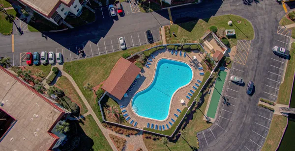 an aerial view of a house with a swimming pool outdoor seating
