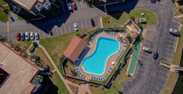 an aerial view of a house with a swimming pool outdoor seating