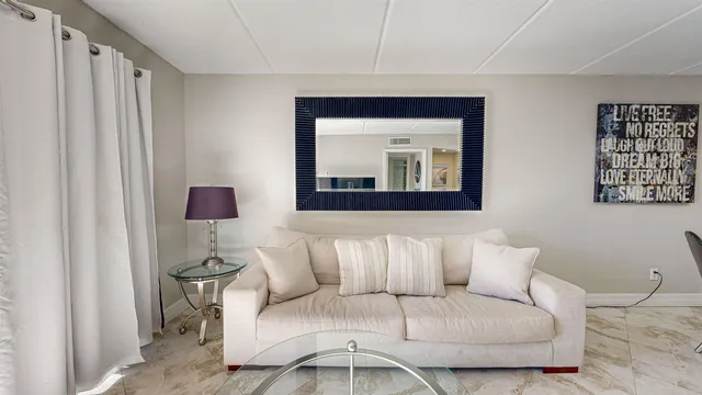 a living room with furniture and a white wall