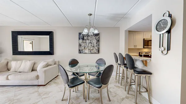 a view of a dining room with furniture and a chandelier