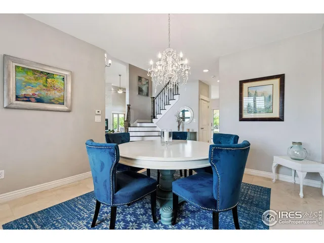 a view of a dining room with furniture and chandelier