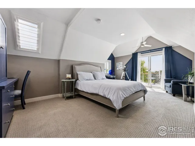 a bedroom with a bed a table and chair