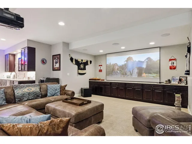 a living room with furniture kitchen view and a large window