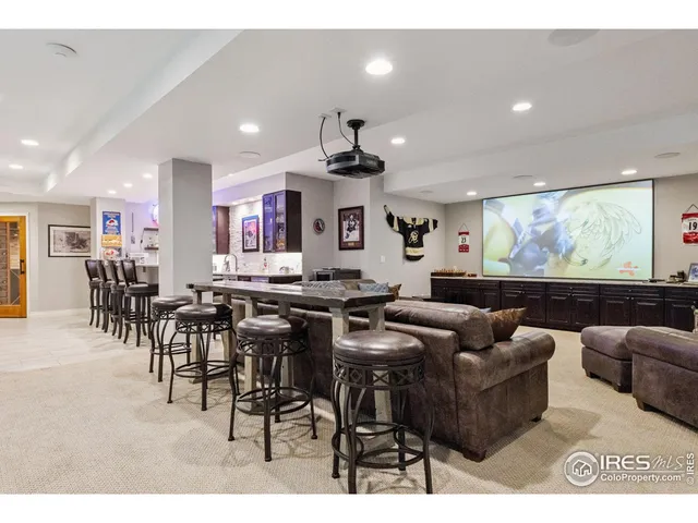 a living room with lots of furniture and kitchen view