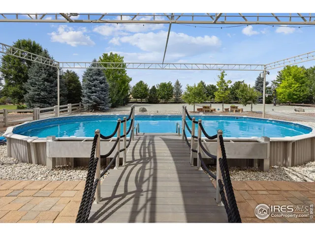 a view of swimming pool with seating space