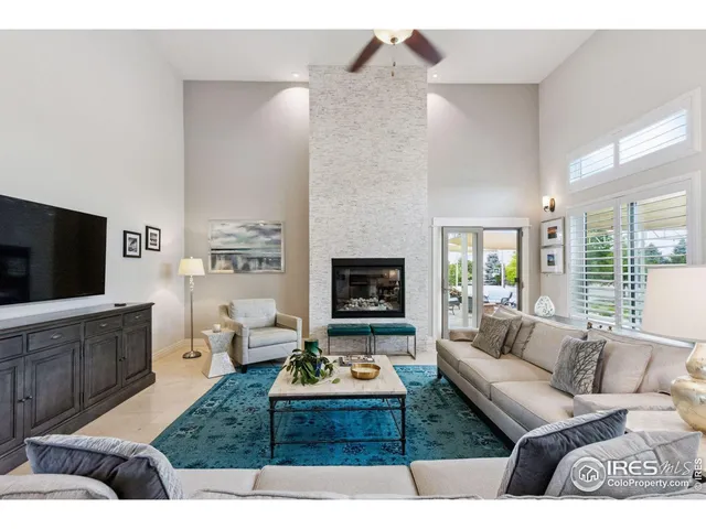 a living room with furniture wooden floor and a flat screen tv