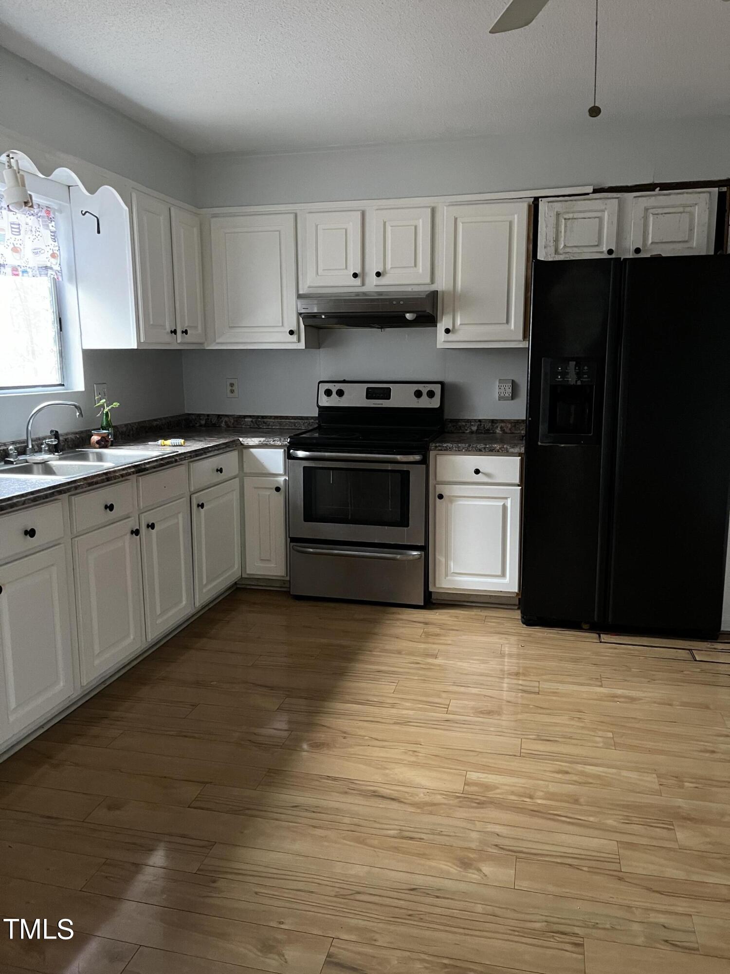 8017 Bunny Road Rougemont, NC 27572 - Photo 3 of 11 a kitchen with granite countertop a refrigerator stove top oven and sink