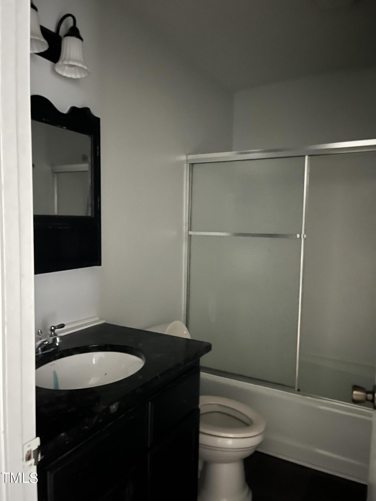 8017 Bunny Road Rougemont, NC 27572 - Photo 6 of 11 a bathroom with a granite countertop sink toilet and mirror