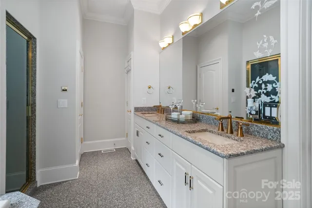 a bathroom with granite countertop a sink and a mirror