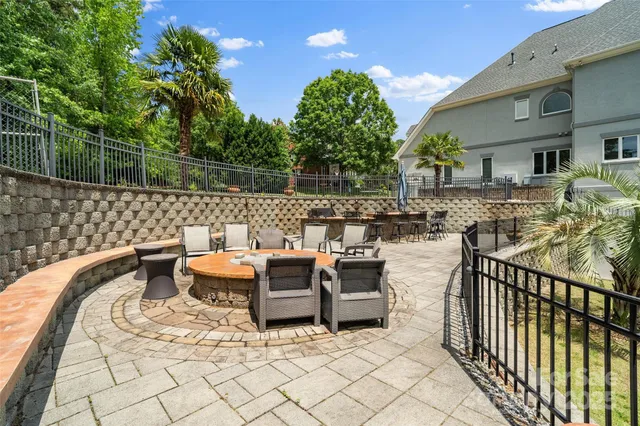 a view of a patio with table and chairs with wooden floor and fence