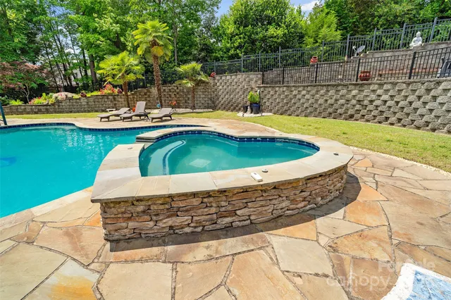a view of a house with swimming pool and sitting area