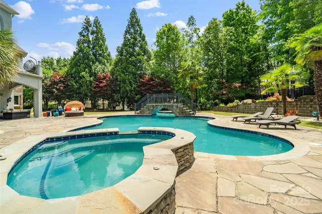 a view of a swimming pool with a yard