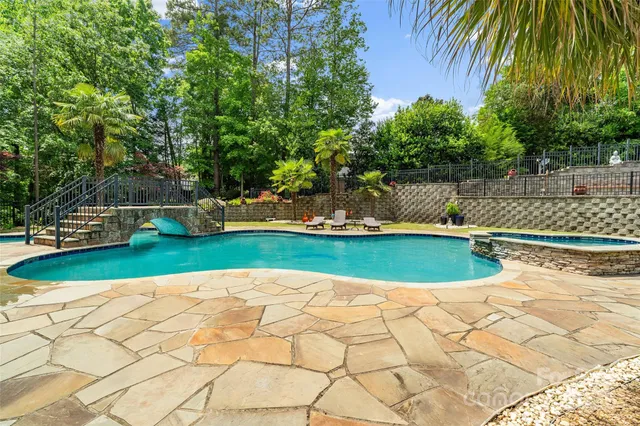 an aerial view of a house with a swimming pool patio and outdoor seating