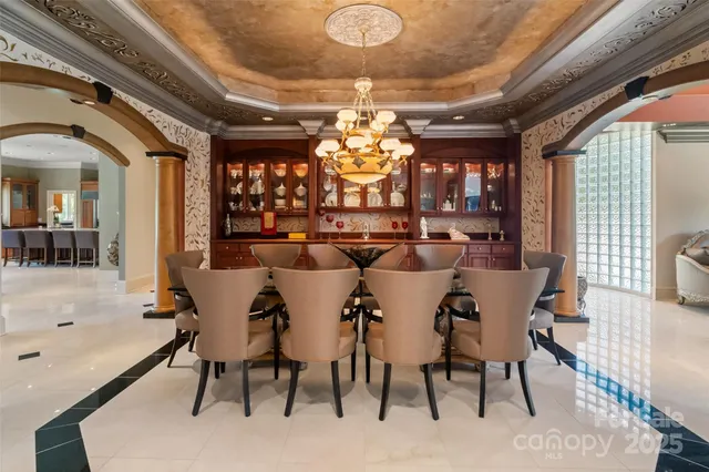 a view of a dining room with furniture wooden floor and chandelier