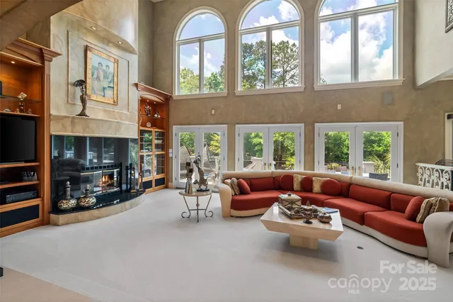 a living room with furniture fireplace and a large window