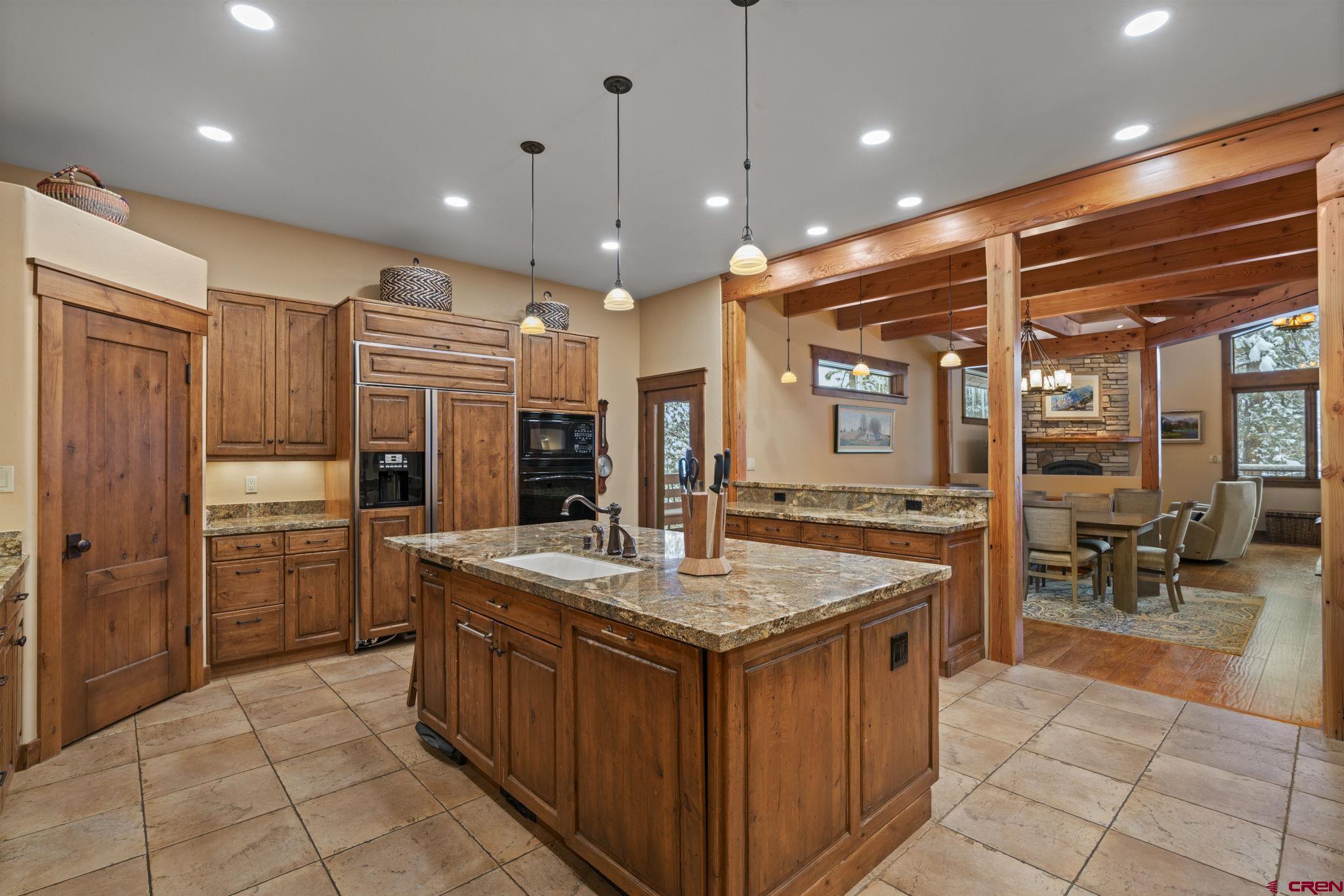 680 The Golden Dipper Road Durango, CO 81301 - Photo 11 of 35 a kitchen with stainless steel appliances granite countertop a stove a sink and a refrigerator