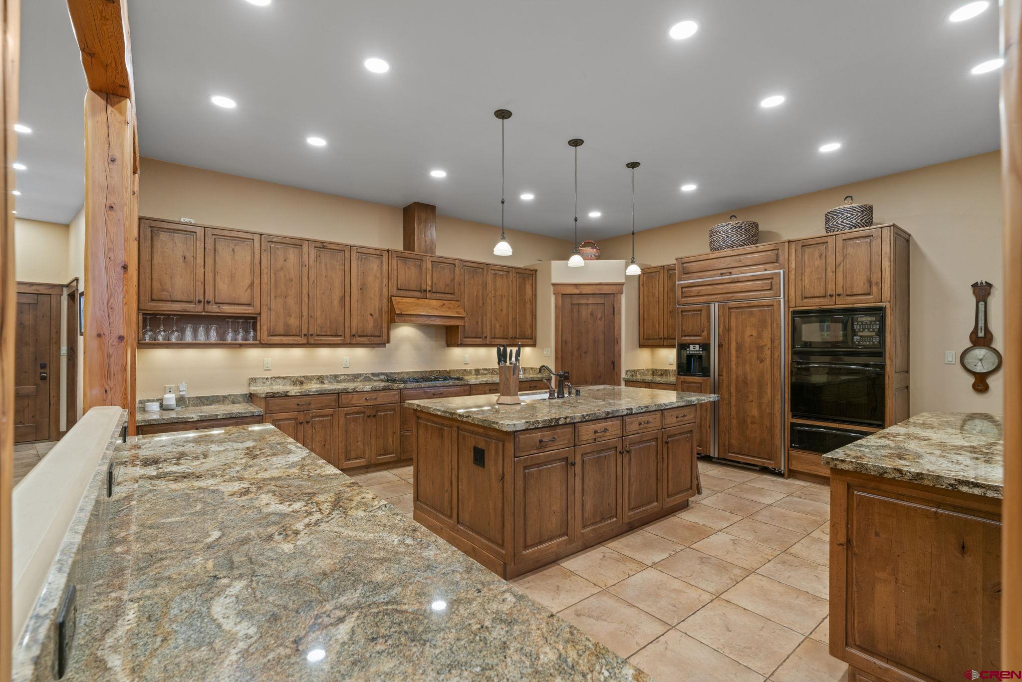 680 The Golden Dipper Road Durango, CO 81301 - Photo 12 of 35 a kitchen with stainless steel appliances granite countertop a stove and a refrigerator
