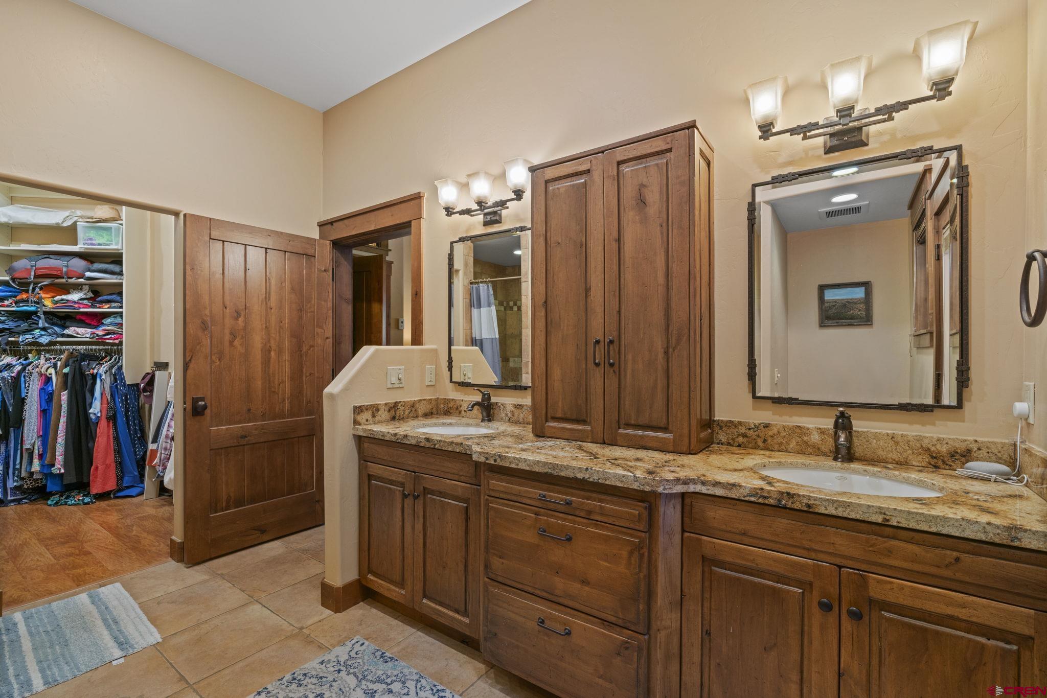 680 The Golden Dipper Road Durango, CO 81301 - Photo 16 of 35 a bathroom with a granite countertop sink and a mirror
