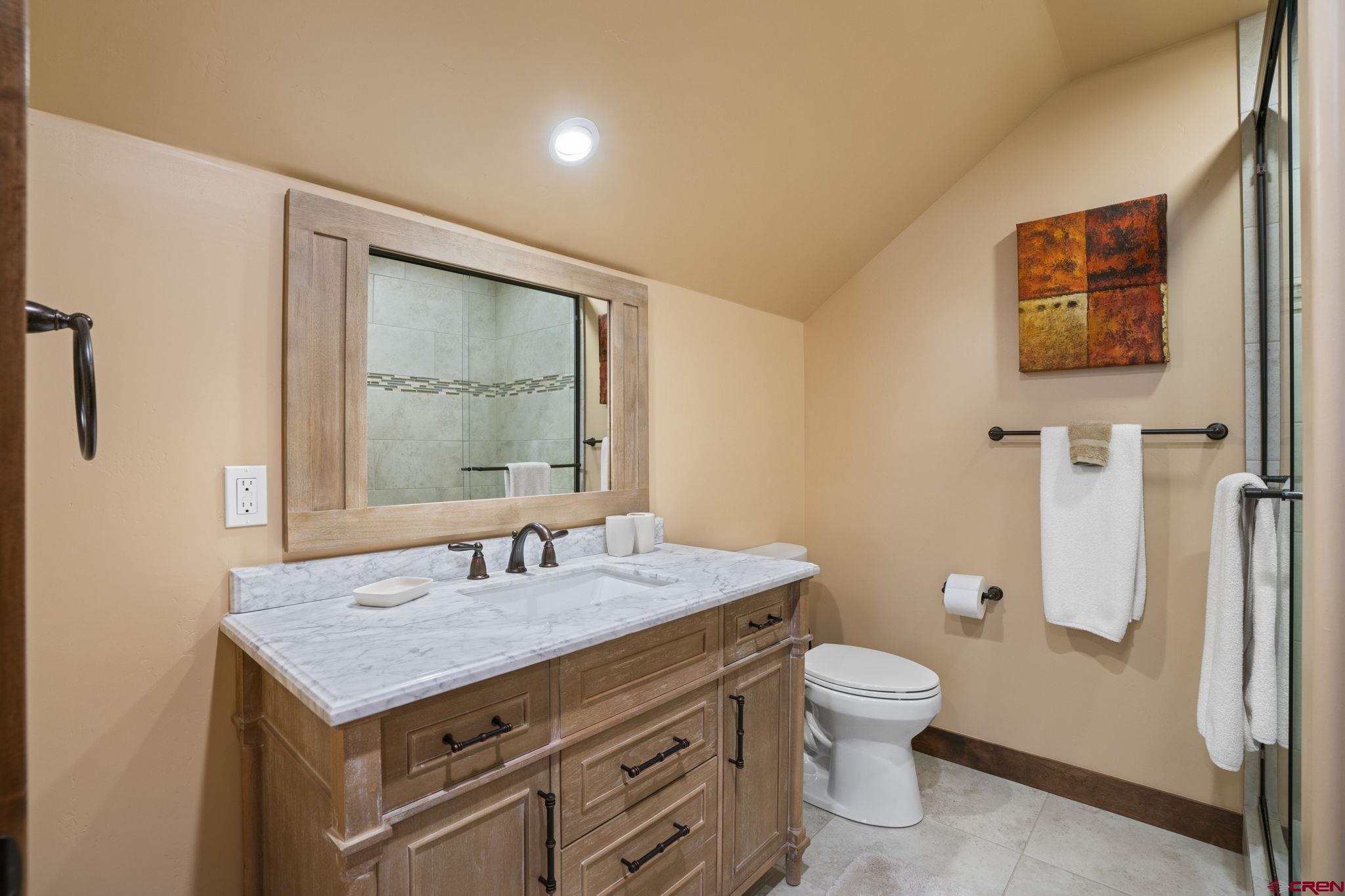 680 The Golden Dipper Road Durango, CO 81301 - Photo 24 of 35 a bathroom with a granite countertop sink and a toilet