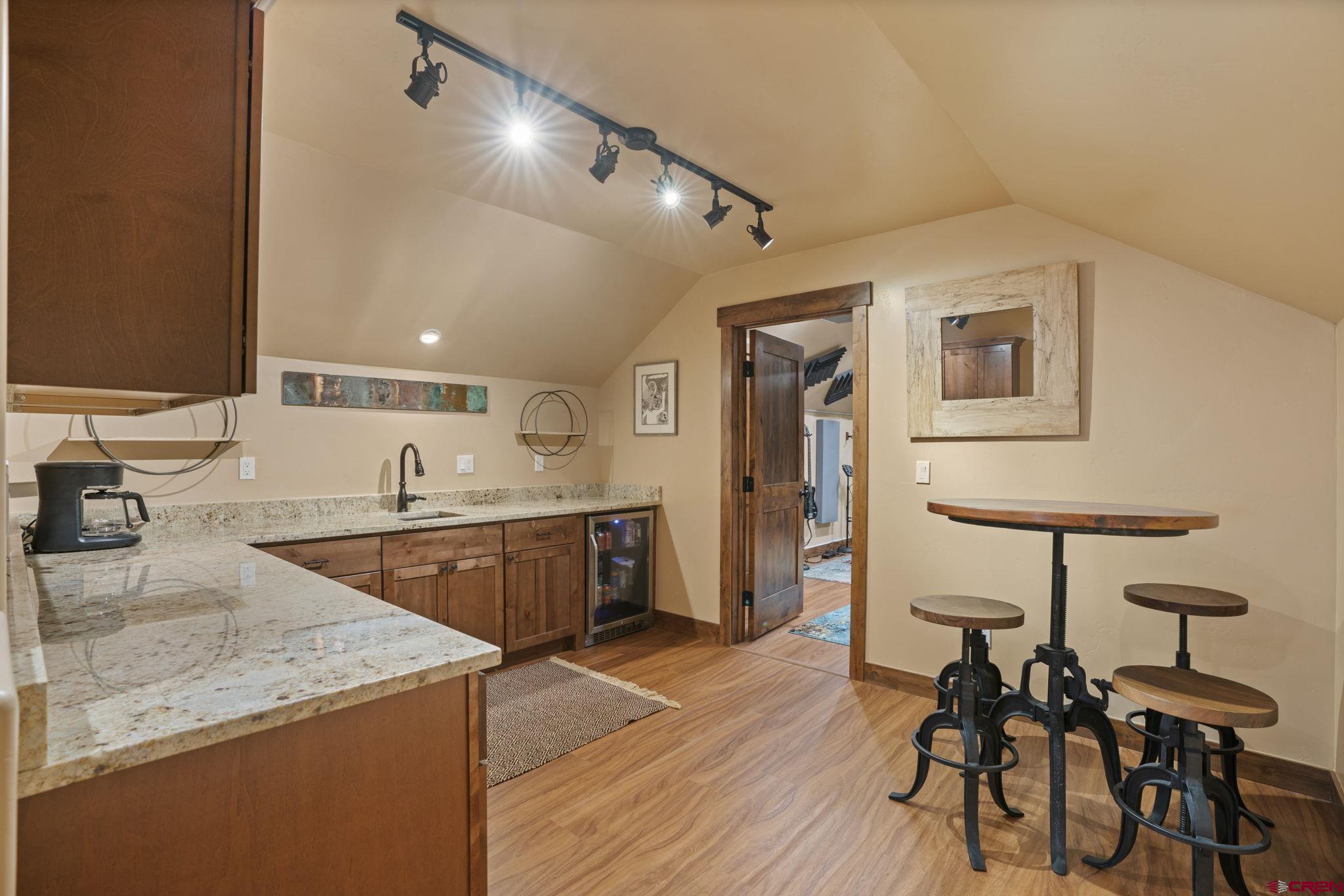 680 The Golden Dipper Road Durango, CO 81301 - Photo 25 of 35 a kitchen with a sink cabinets and wooden floor