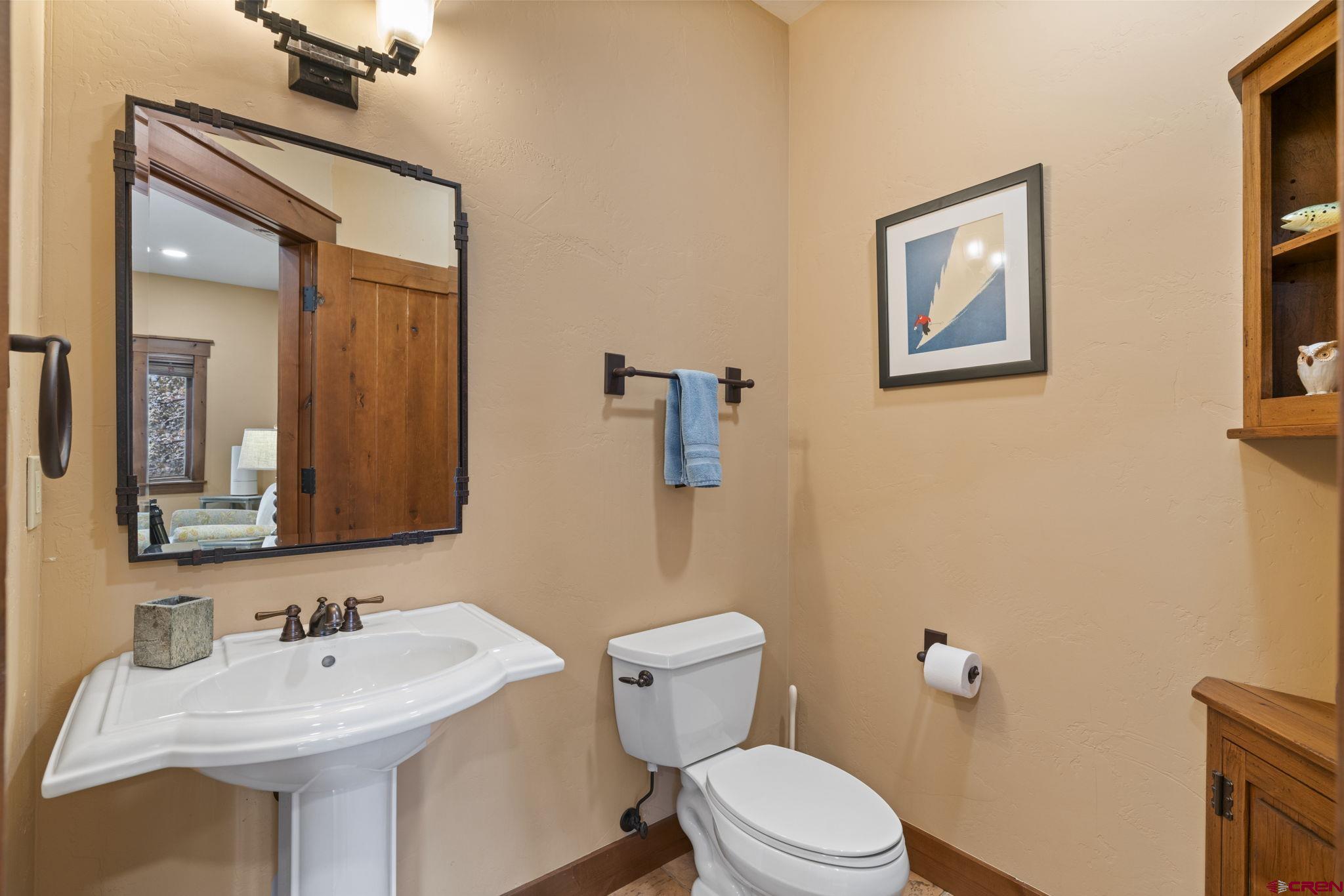 680 The Golden Dipper Road Durango, CO 81301 - Photo 31 of 35 a bathroom with a toilet sink and mirror